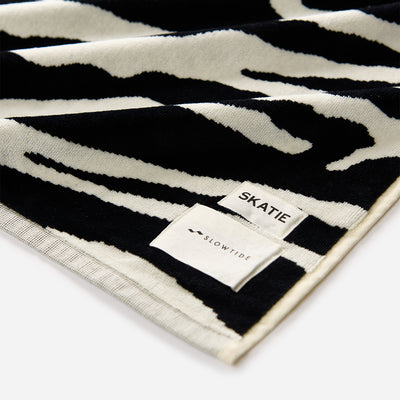 Velour towel with black and white zebra print pattern.