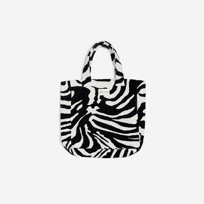 Tote bag, cotton canvas with zebra print and handles, plain background.
