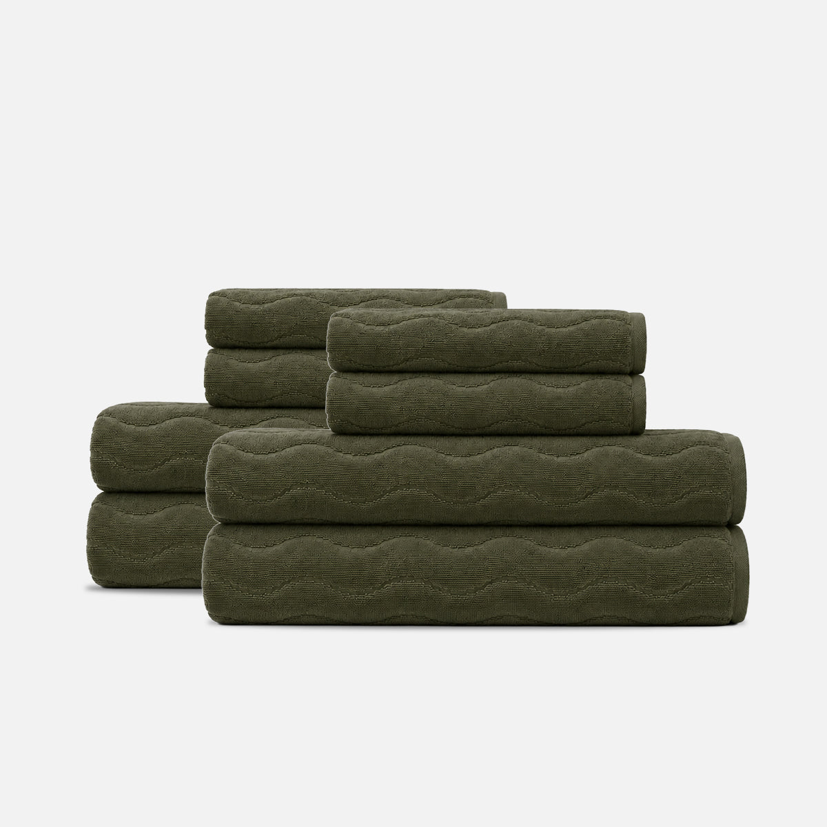 Bath towel set, dark green cotton with sculpted wave texture, stacked.