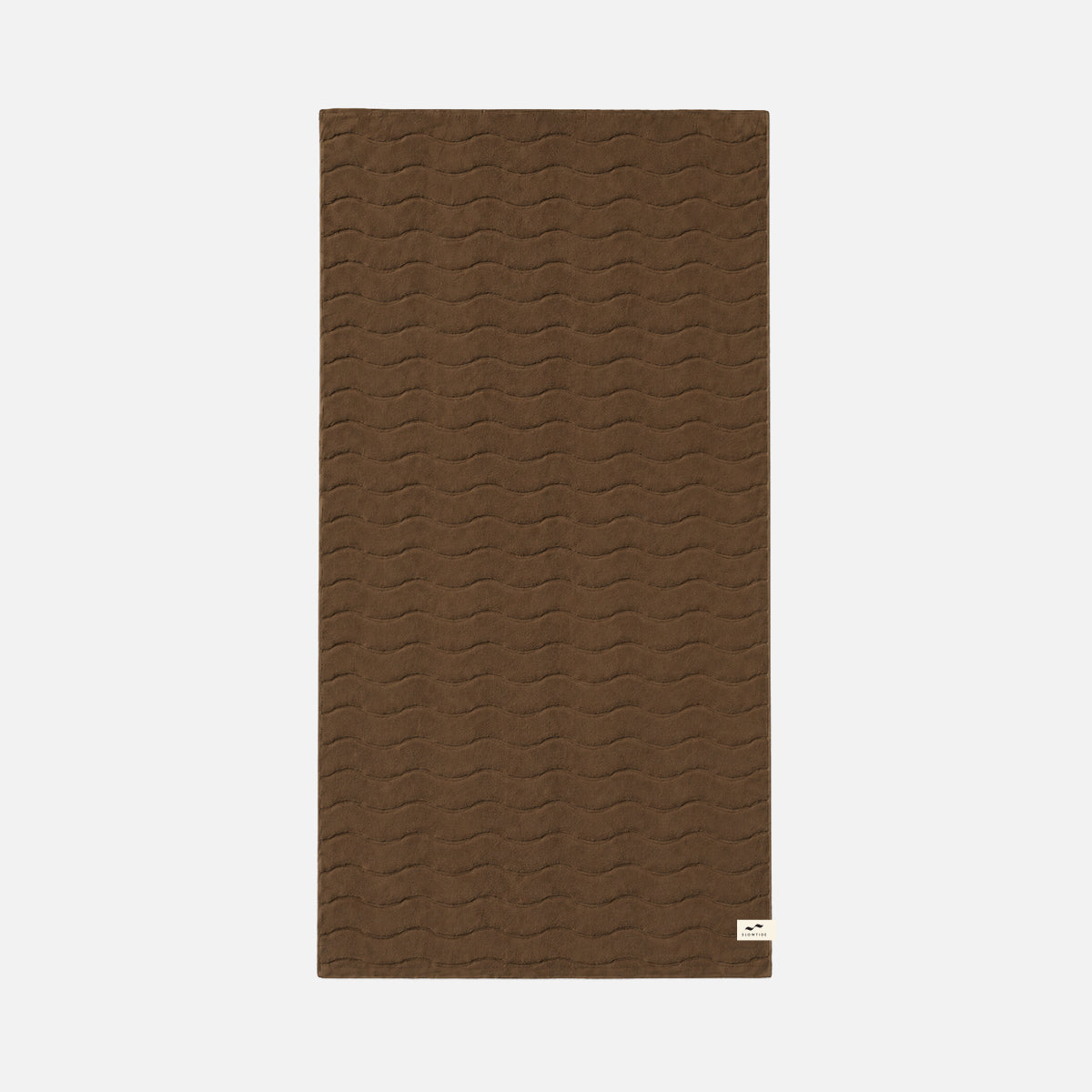 Brown bath towel with wavy sculpted texture and small white corner label.