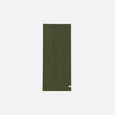 Green cotton bathroom towel with subtle wavy texture, shown on white background.