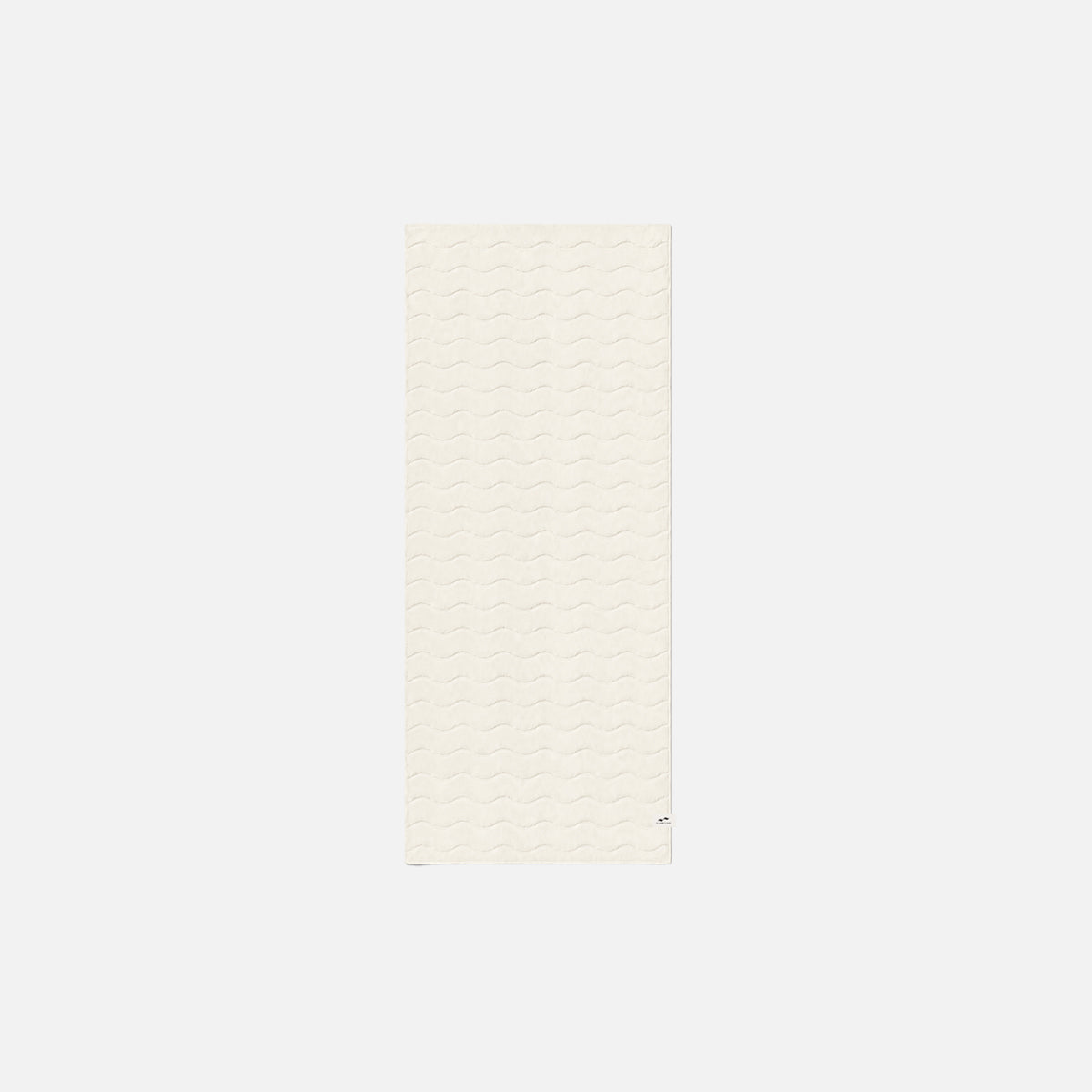 Cotton towel with plush feel and wavy texture on a simple background.
