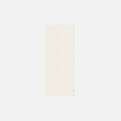 Cotton towel with plush feel and wavy texture on a simple background.