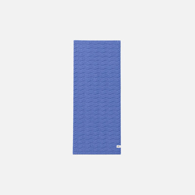 Blue plush cotton towel with wavy stitched pattern on a white background.