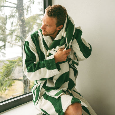 Plush terry cloth bathrobe in a green and white striped pattern.