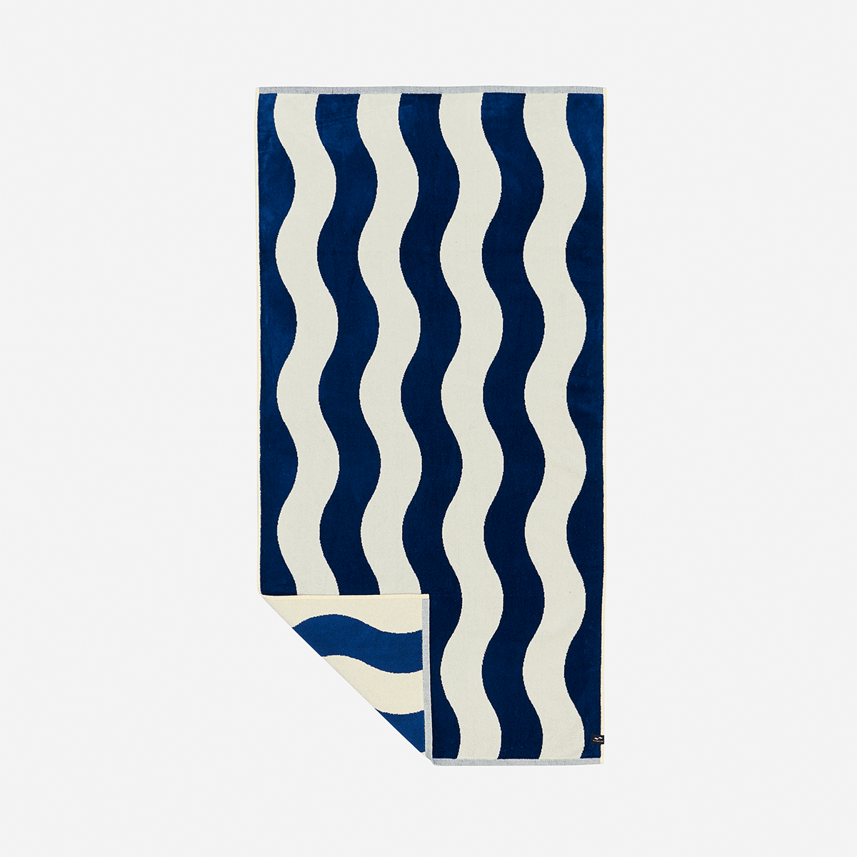 Cotton beach towel with navy blue and white wavy vertical stripes.