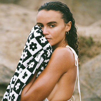 Bath towel, cotton, black and white pattern, outdoor setting.