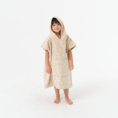 Cotton terry hooded towel poncho with floral pattern.