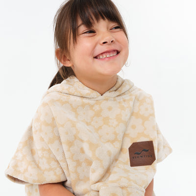 Kids poncho in beige floral cotton terry with logo patch.
