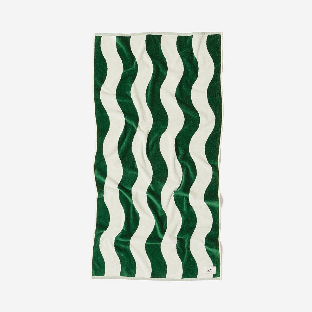 Cotton towel with green and white wavy stripes, laid flat.