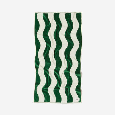 Cotton towel with green and white wavy stripes, laid flat.
