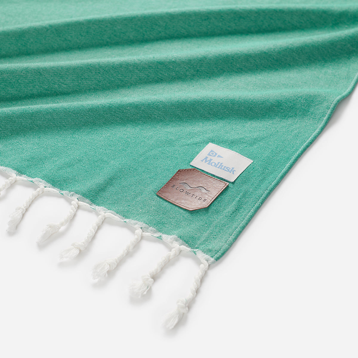 Cotton blanket with white tassels and two corner labels, oversized design.