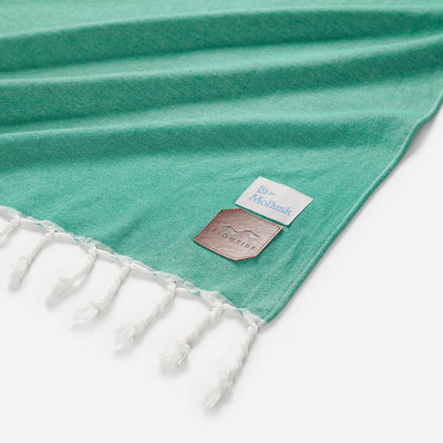 Cotton blanket with white tassels and two corner labels, oversized design.