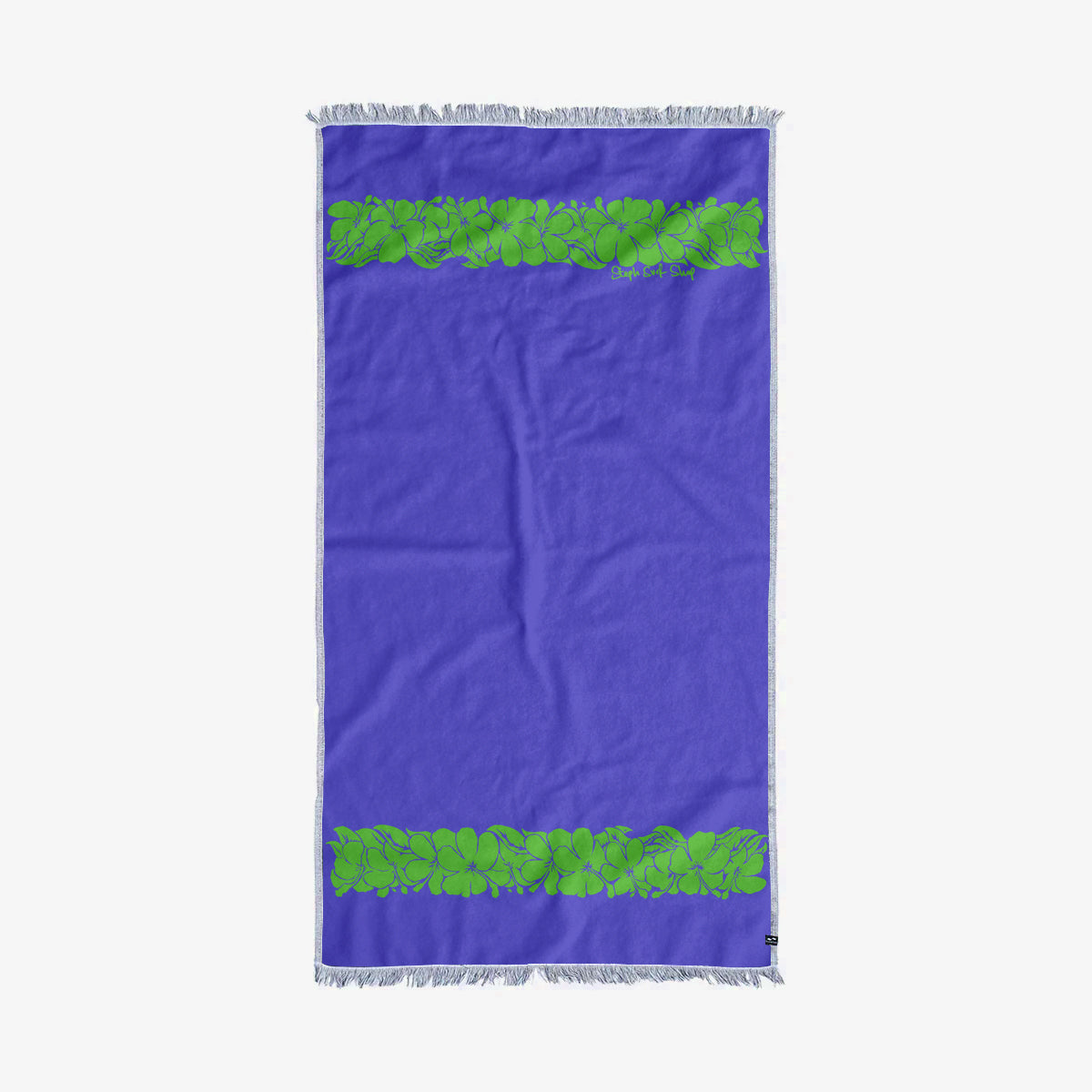 Turkish towel, sand-resistant cotton with green leaf pattern and fringed edges for beach use.