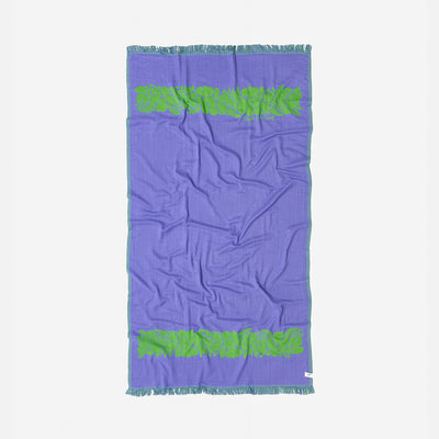 Turkish towel with purple color, green fringe, and leaf pattern, sand-resistant design.