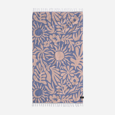 Towel with blue and beige botanical print, abstract sun design, fringe edges.