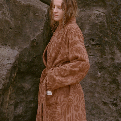 Brown patterned robe with pockets, lightweight fabric.