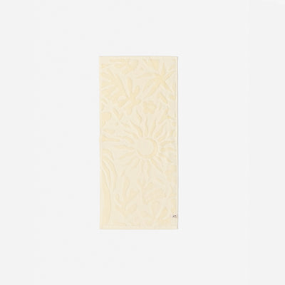 Cream cotton towel with sculpted floral and raised sun pattern, 550 GSM, for bath use.