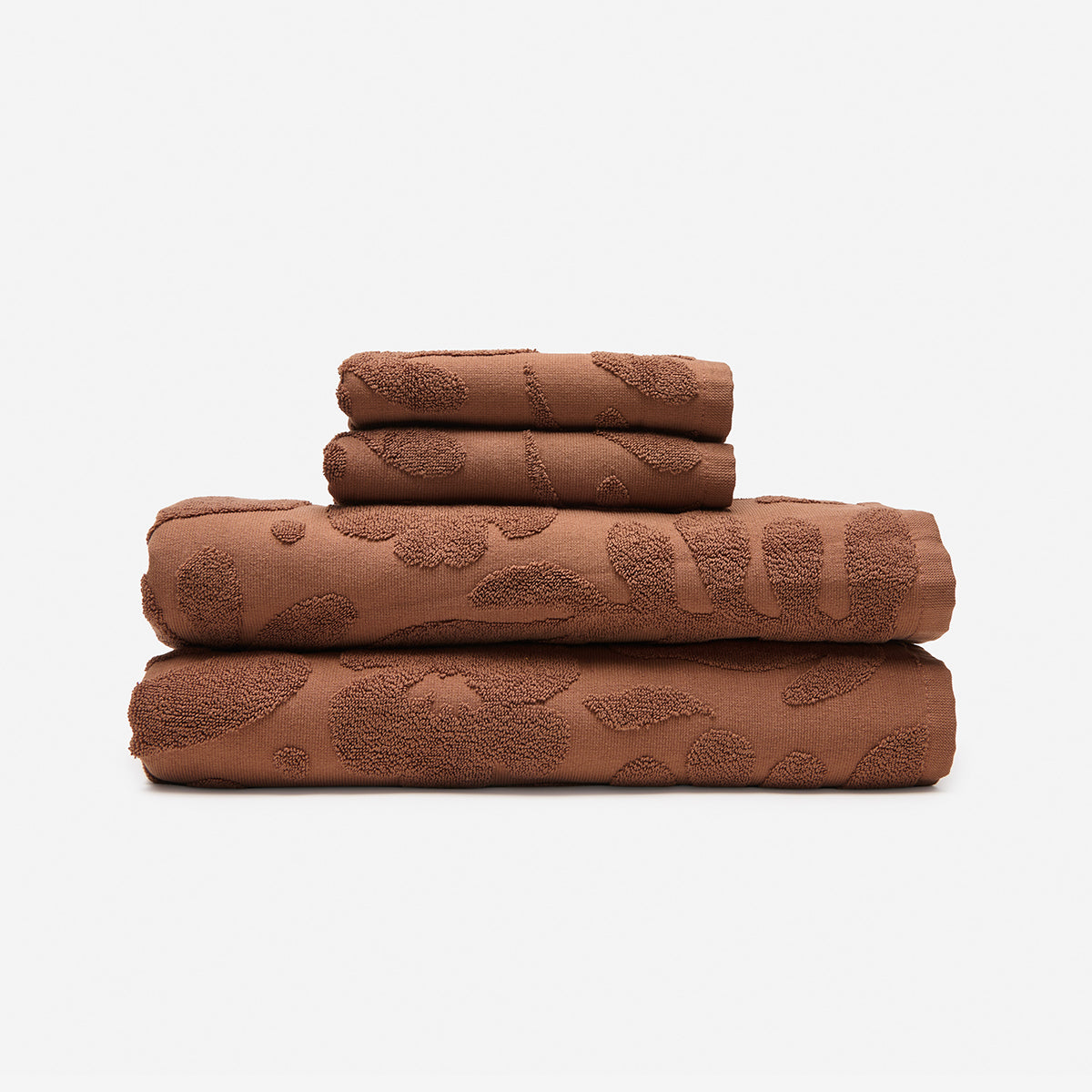 Cotton towels 550 GSM with textured abstract pattern, stacked set of four.