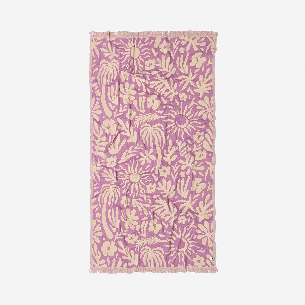 Towel with beige botanical print and fringe edges on white fabric.