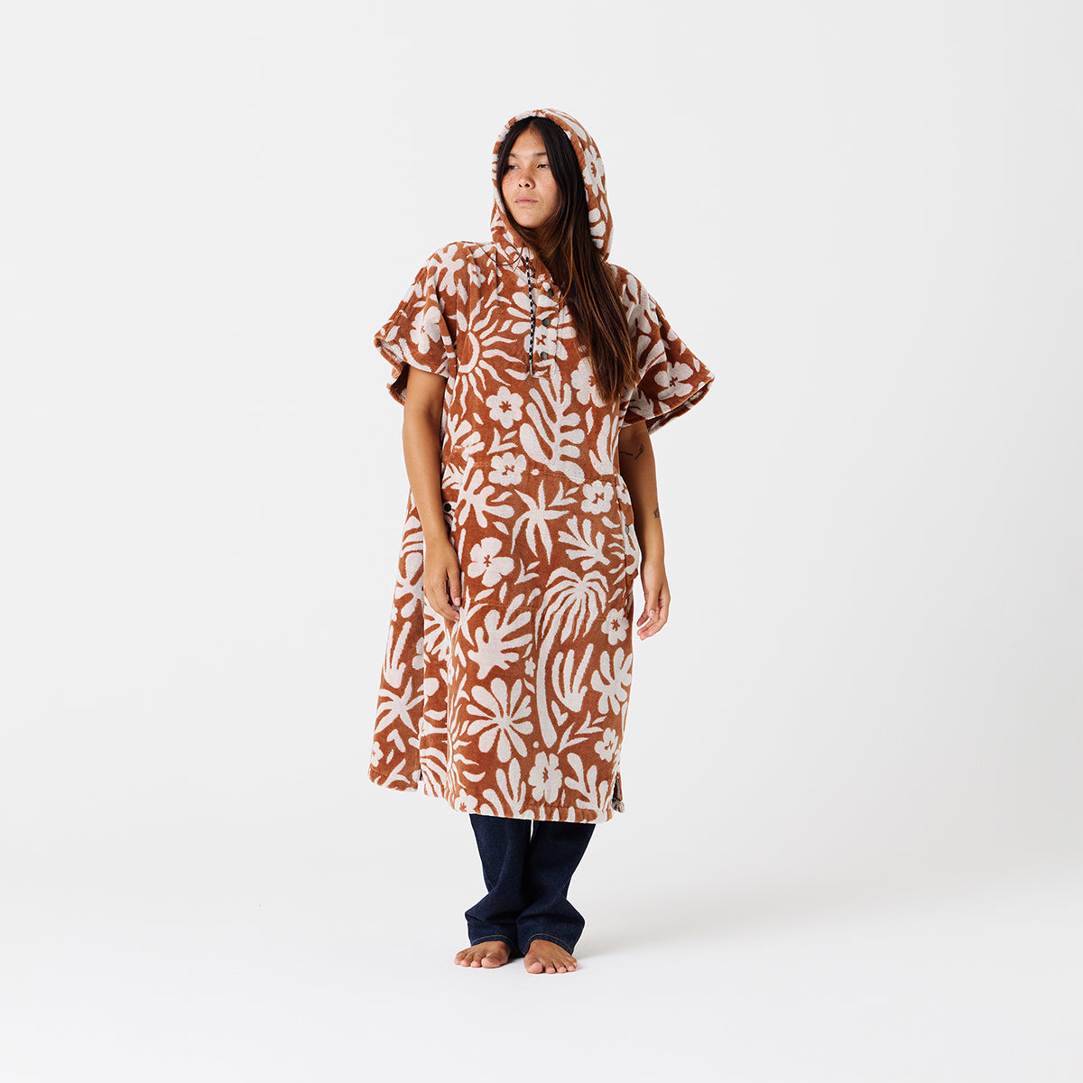 Hooded poncho towel in extra-warm cotton terry with brown and white floral pattern.