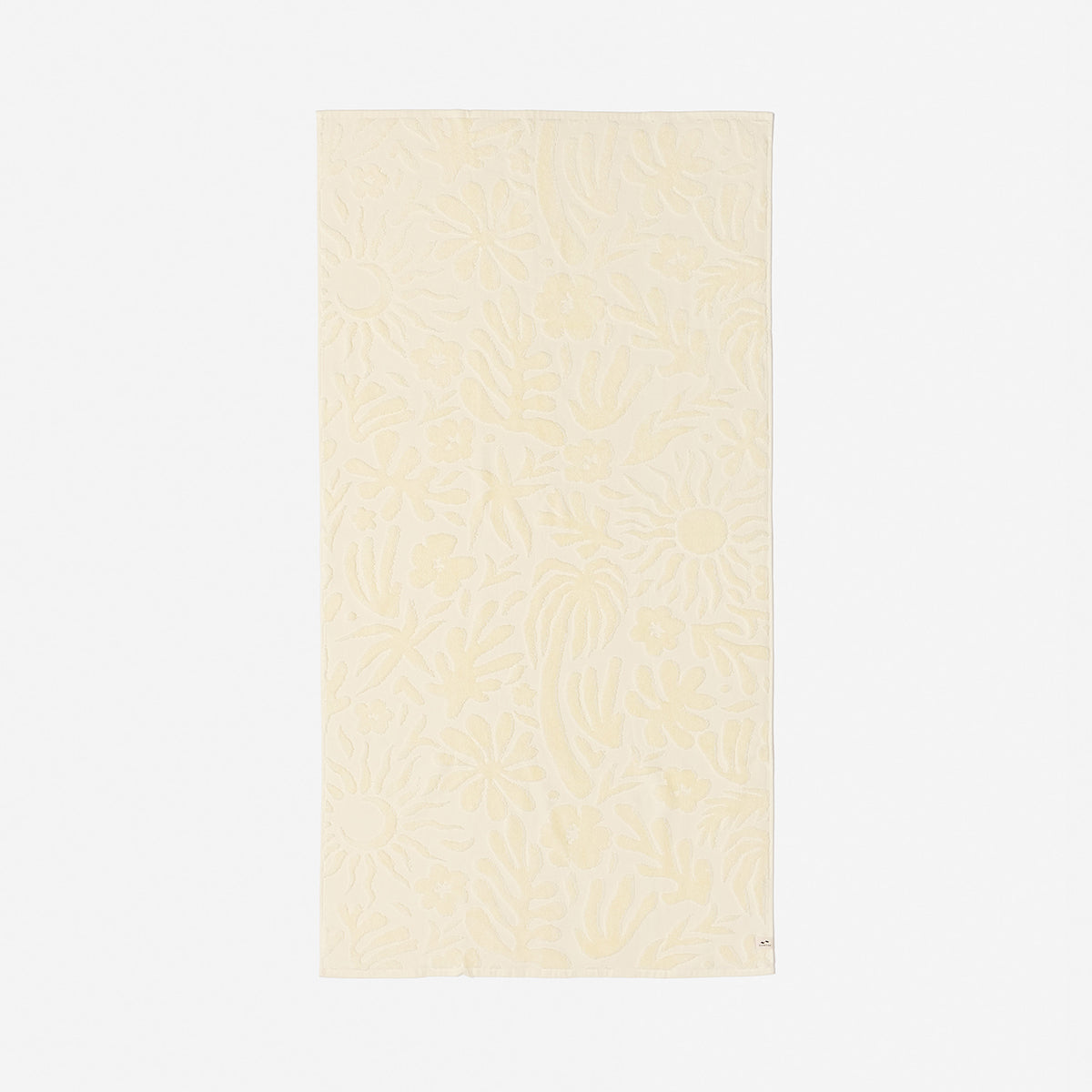 Cotton towel in beige with plush texture and subtle floral pattern for bathroom use.
