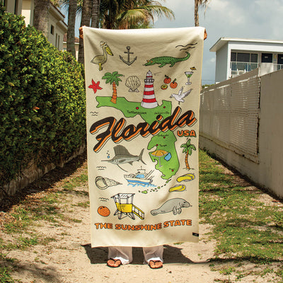 Beach towel, recycled material, Florida icons and The Sunshine State text.