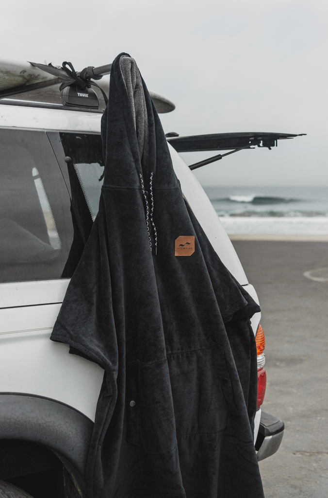 surf changing poncho hanging from side of van