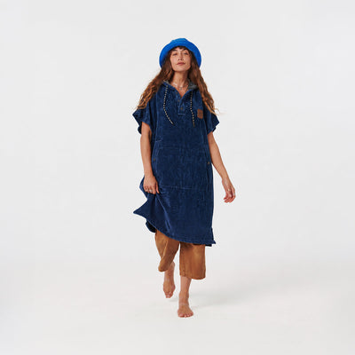 Blue hooded towel poncho with tan pants and blue hat.