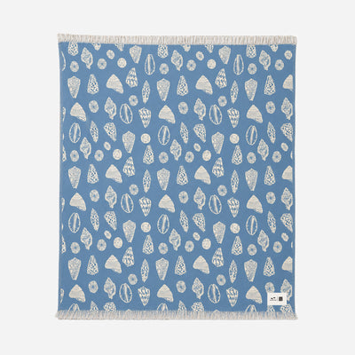Cotton blanket with white geometric pattern and fringe, oversized and gauzy.