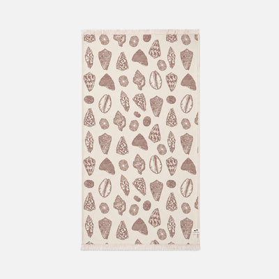 Beige sand-resistant towel with brown seashell and rock pattern on a plain background.