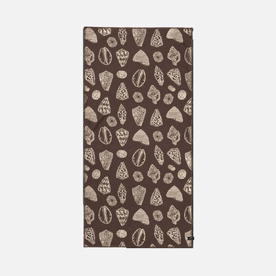 Brown sand-free towel with beige seashell pattern on white background.