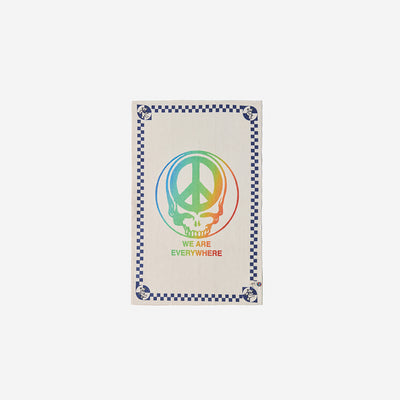 Kitchen towel with rainbow peace sign, skull, and checkerboard border.