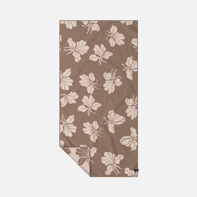Sand-free towel in a brown and cream floral pattern.