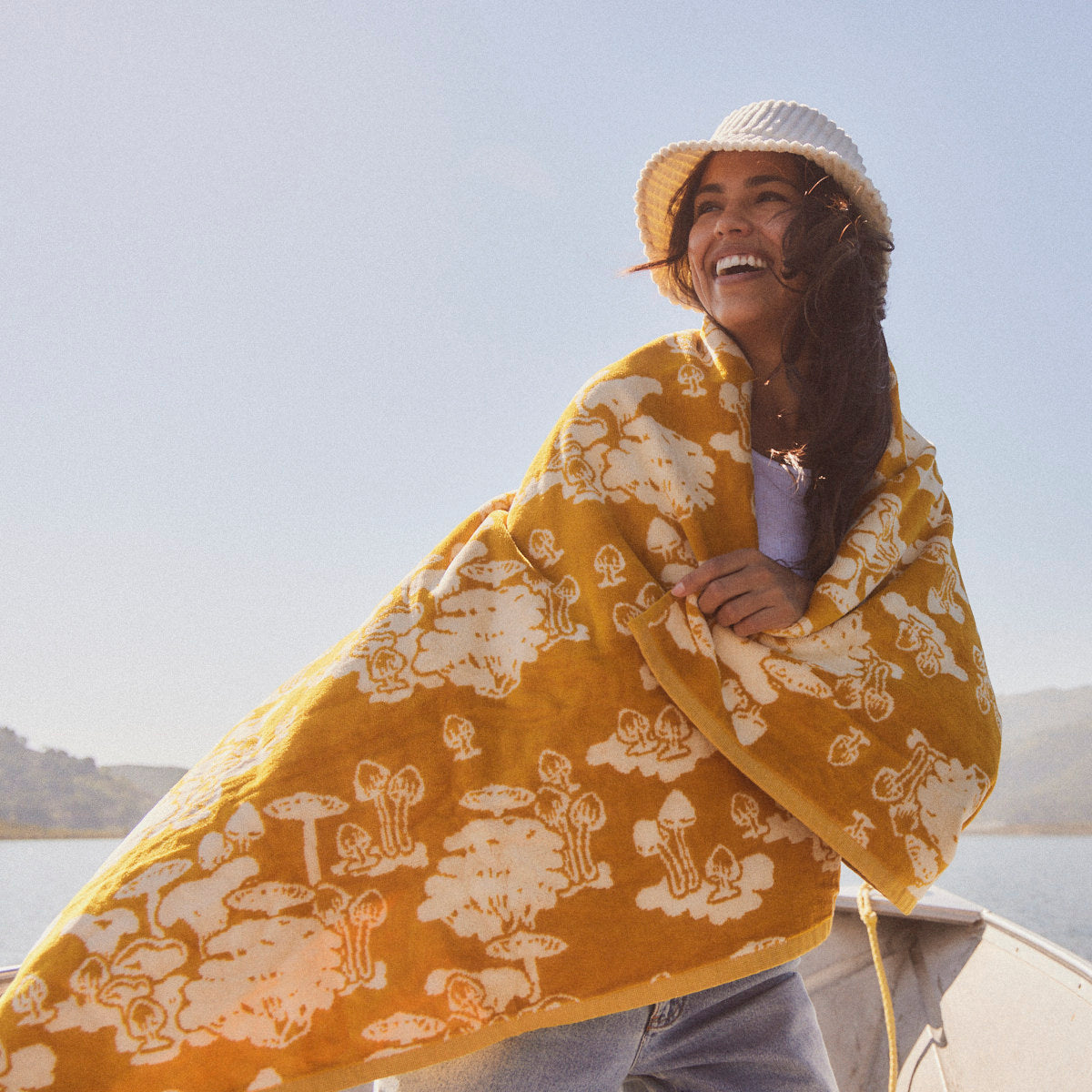 Cotton jacquard weave blanket with sustainable sourcing, displayed outdoors.