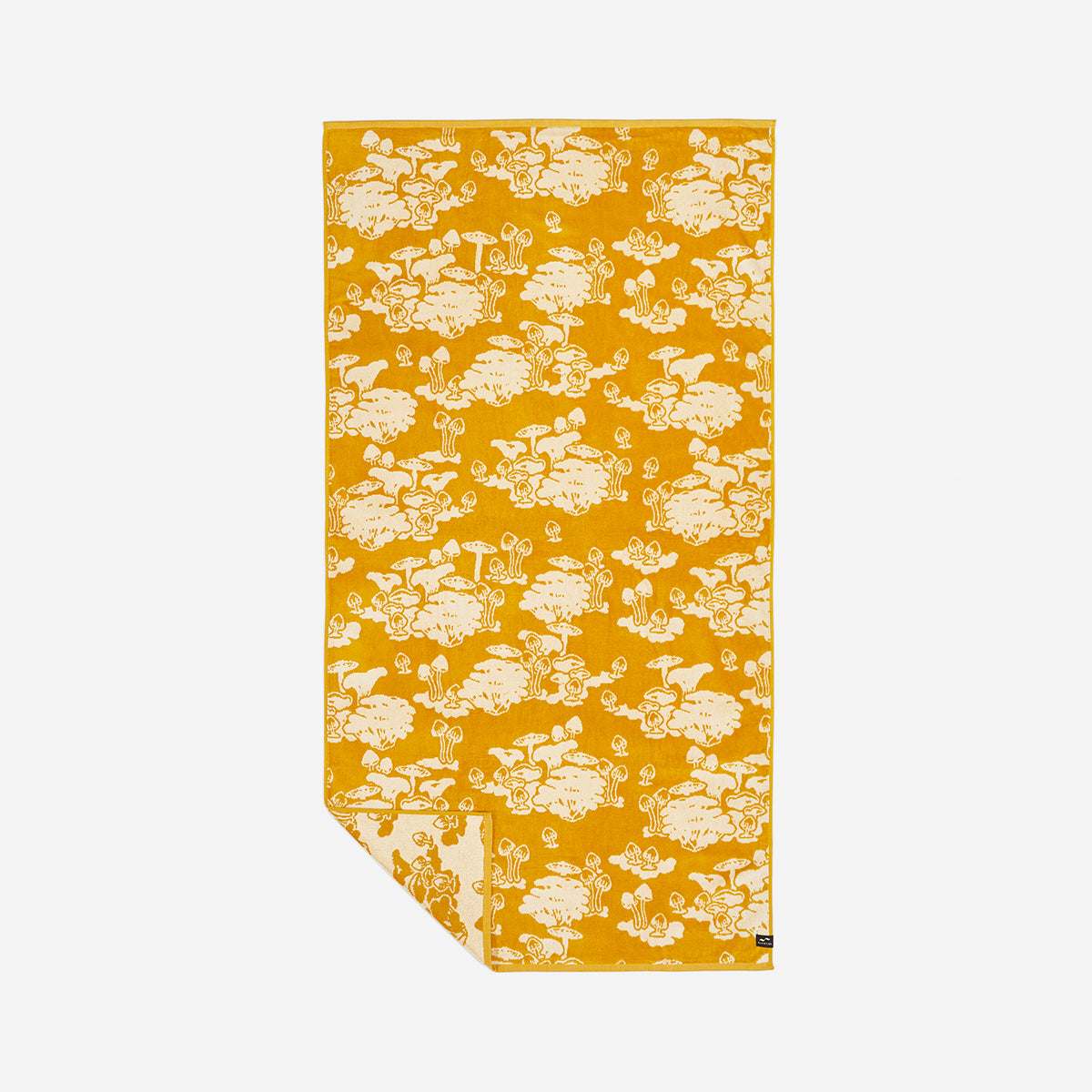 Beach towel with yellow and white sheep and mushroom jacquard pattern.