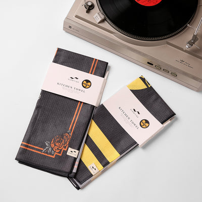 Eco-friendly kitchen towels, folded, on a white surface.