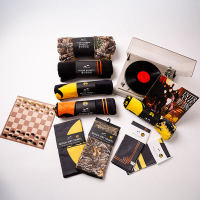 Gift set with velour towel, soft blankets, chessboard, and classic record player.