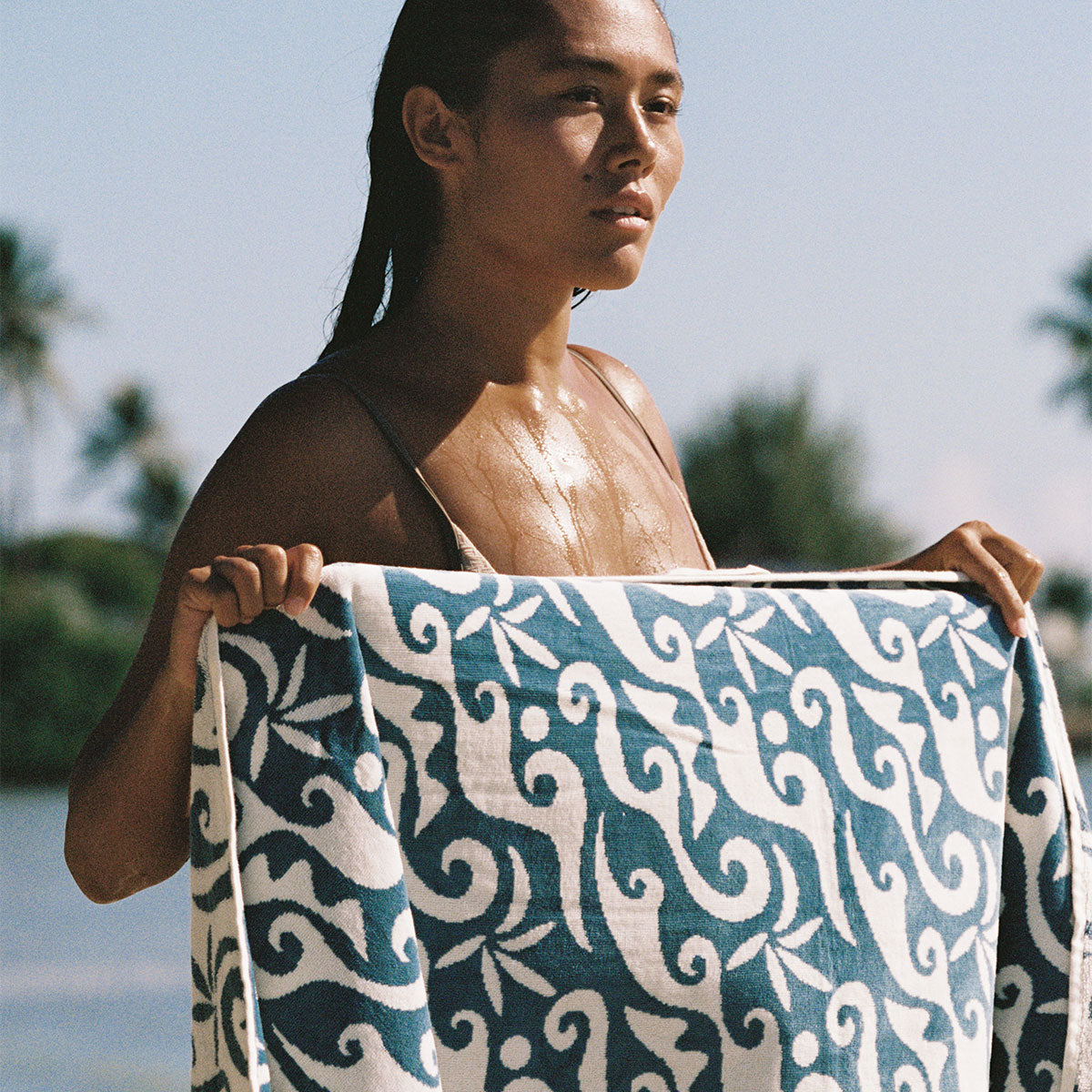 Beach towel with wave print pattern outdoors.