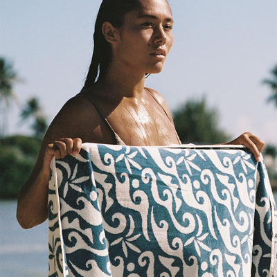 Beach towel with wave print pattern outdoors.