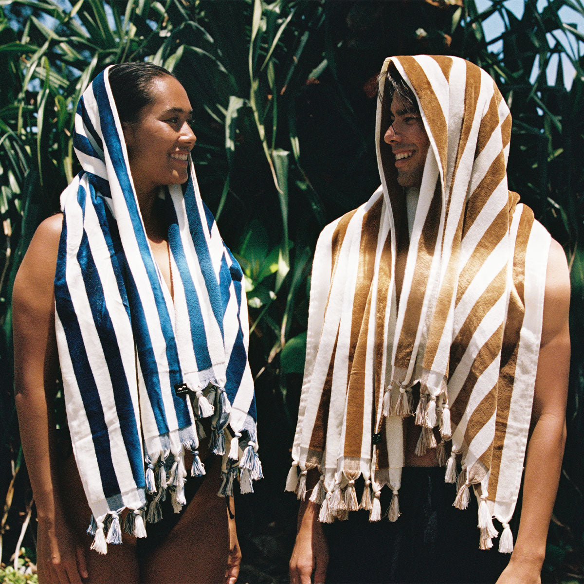 Plush woven beach towel with textured pattern draped outdoors.