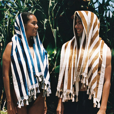 Plush woven beach towel with textured pattern draped outdoors.