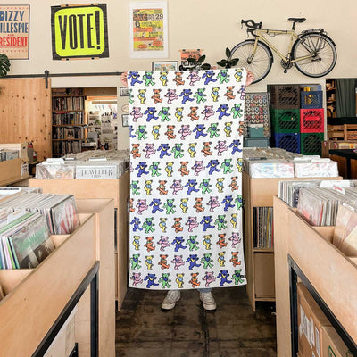 Velour towel with a colorful dancing bear pattern.