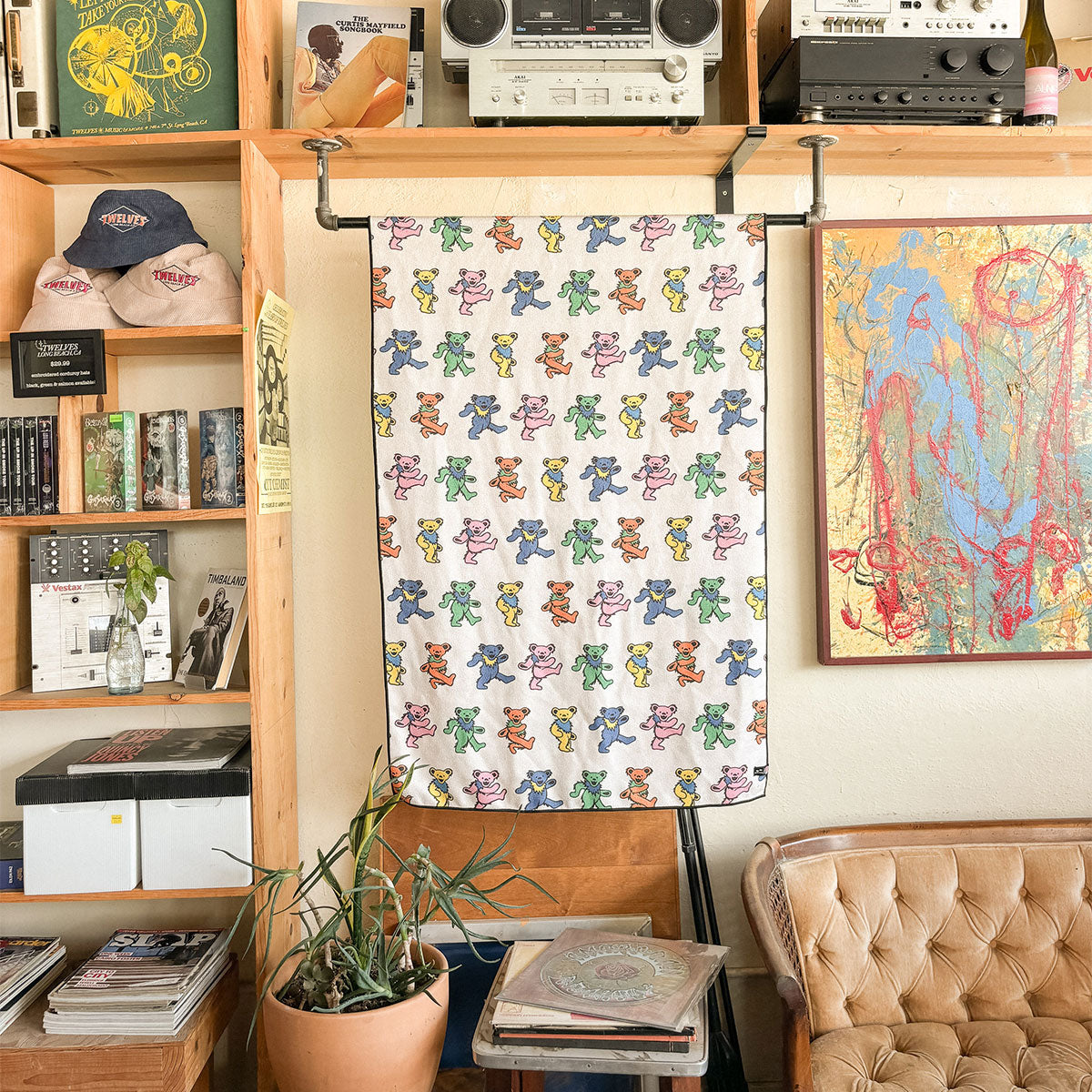 Quick-dry towel made from recycled materials with colorful bear pattern hanging indoors.