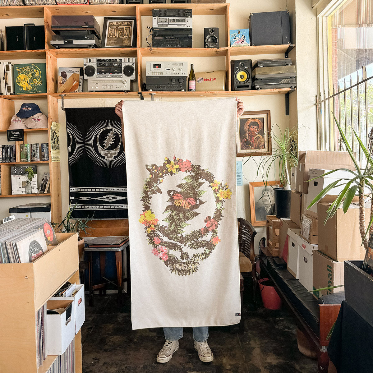 Quick-dry towel with floral and skull design displayed indoors.