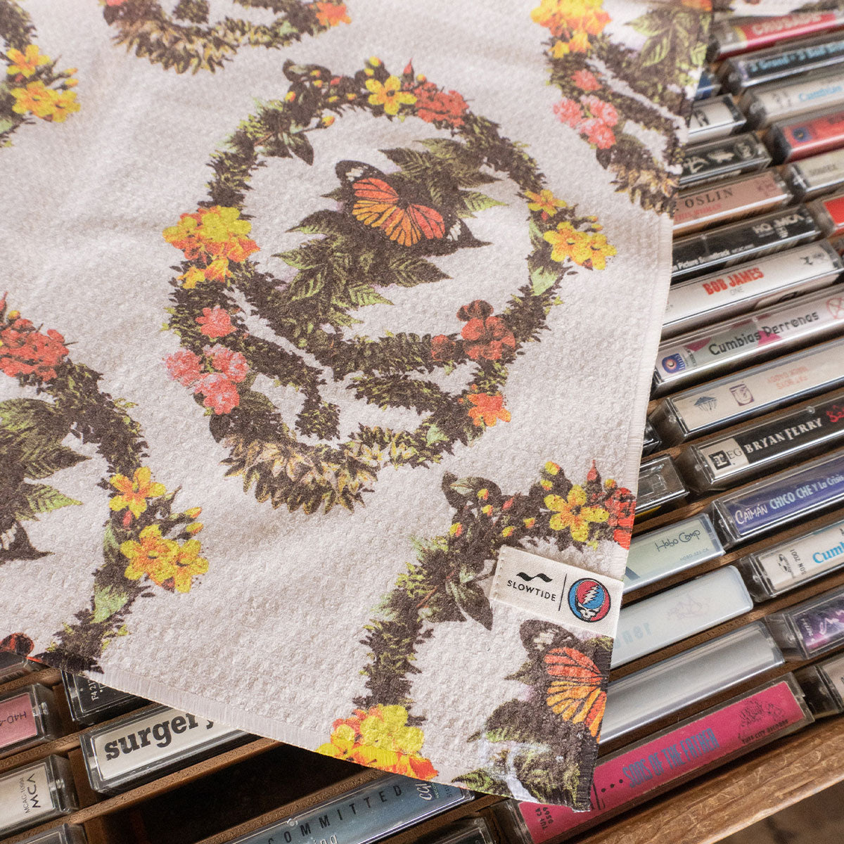 Kitchen towel with botanical butterfly pattern on cassette tapes.
