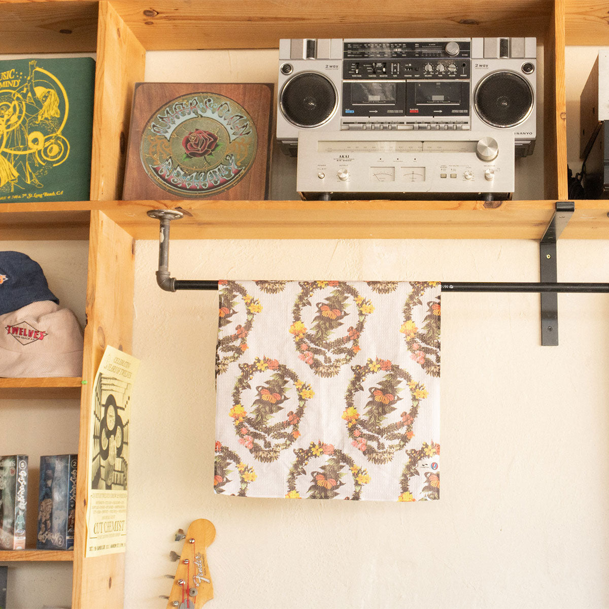 Recycled waffle towel with textured pattern hanging beneath shelf display.