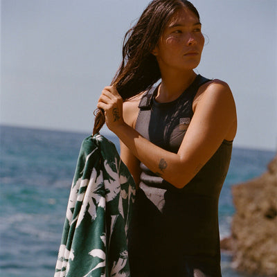 Sleeveless neoprene wetsuit with green palm leaf print velour towel.