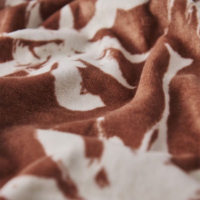 Plush velour fabric with brown and white whale pattern, ultra-absorbent.