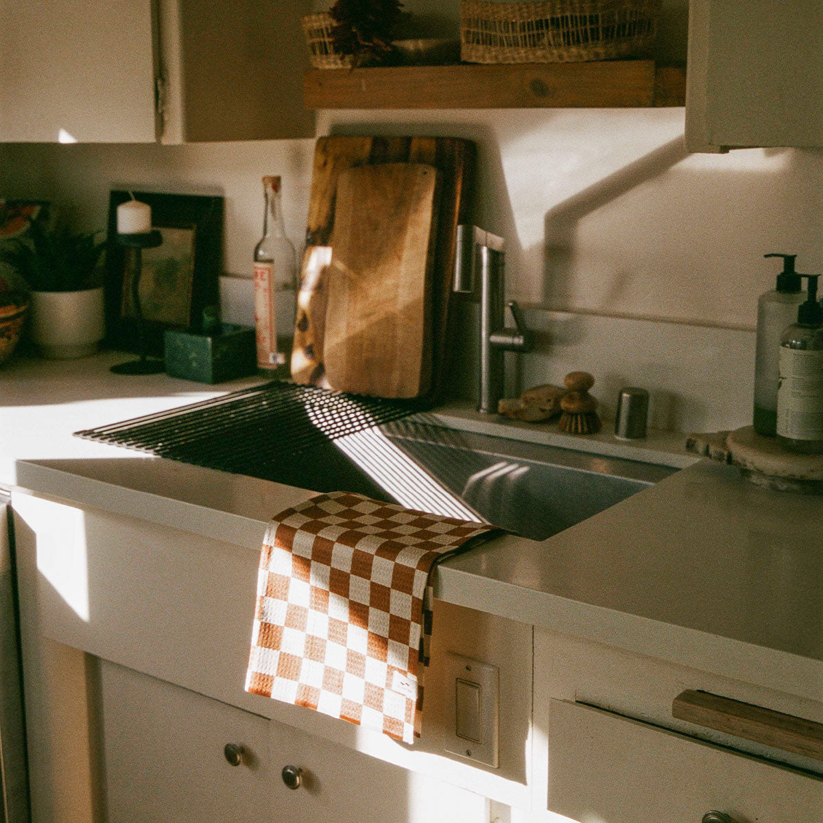Quick dry towel on kitchen counter edge in natural sunlight.